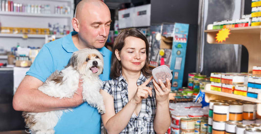 DOG Streamz blog image of man and women choosing what natral dog food to give their dog for an effective balanced diet