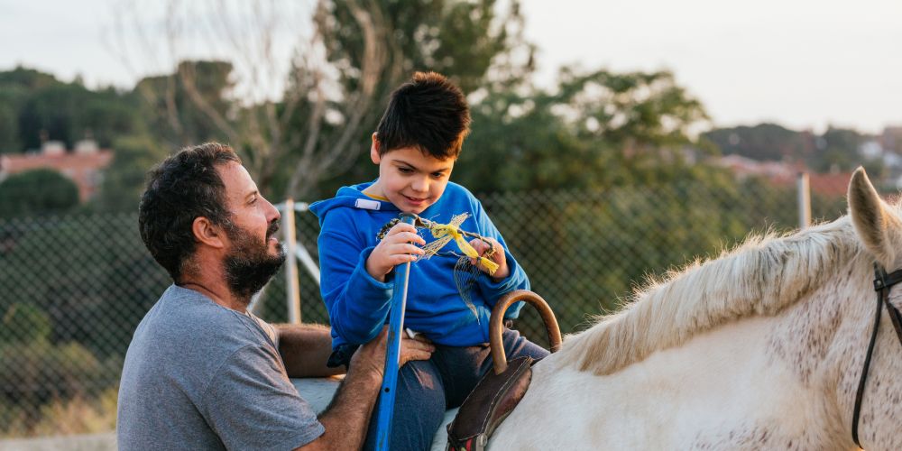 Supporting the Therapy Horses of NCEFT, boy on horse having fun