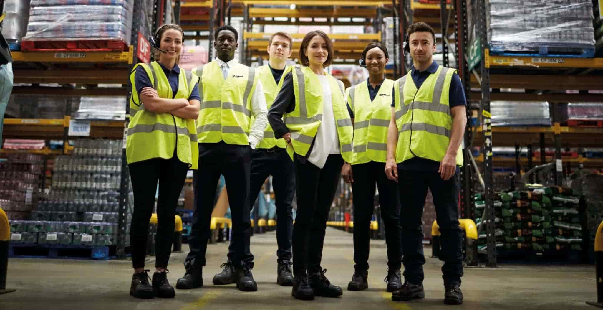 StreamZ Global About Us page. Image of StreamZ Staff standing in fulfilment warehouse.